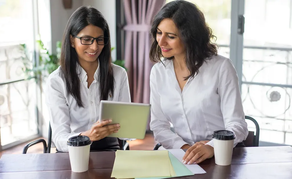 Warm illustration of a financial advisor and client in a clear, trust-based conversation